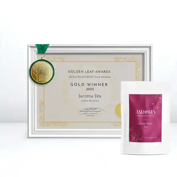 Jaroma Cherry Berry Tea awarded the Gold Winner in the Golden Leaf Awards 2023 for Herbal Blend. The image displays the award certificate with a gold medal and the Cherry Berry Tea packaging.