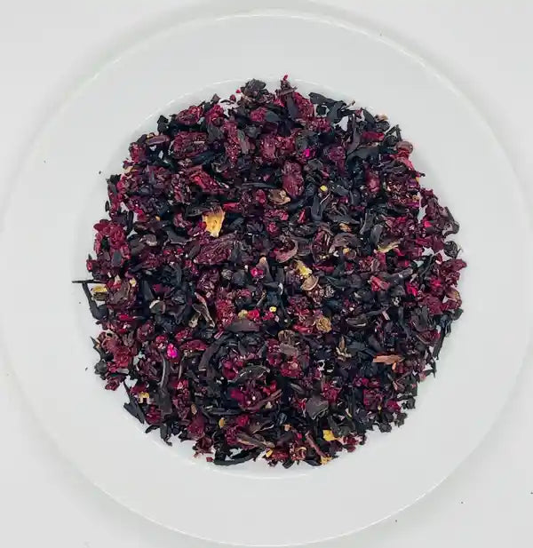 Loose-leaf Jaroma Black Cherry Berry Delight tea blend, showcasing a vibrant mix of organic dried hibiscus petals, black cherry pieces, and rose petals, creating a rich, colourful infusion.